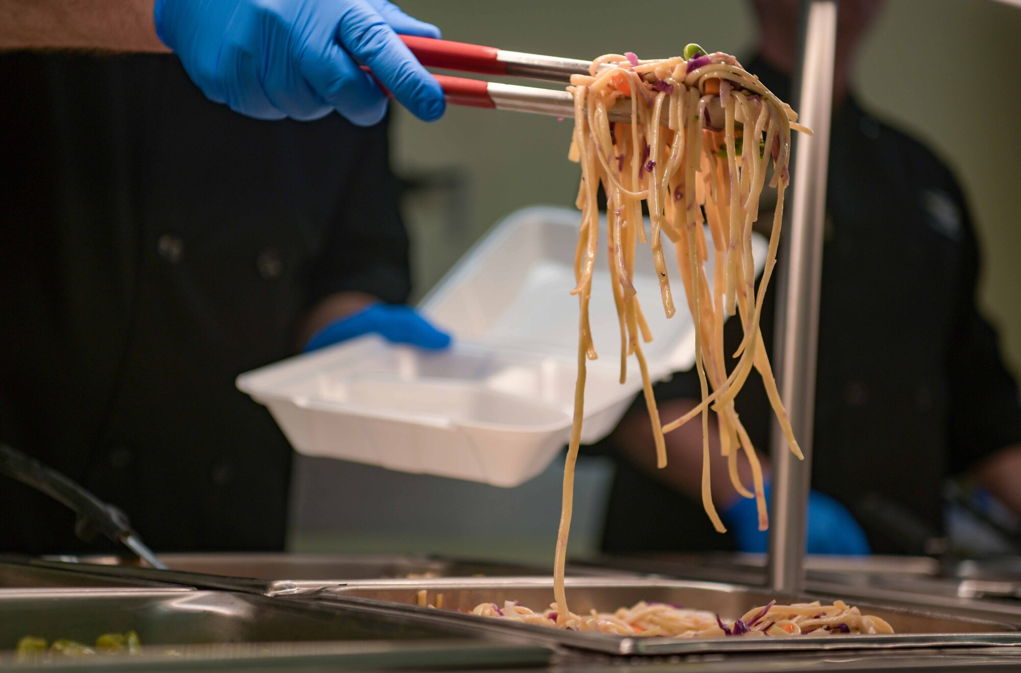 Leaders from across Kadena Air Base, Japan, serve food at the Marshall DFAC to celebrate its reopening May 6, 2024