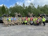 The combined 405th Army Field Support Brigade team made up of Soldiers and Army civilians from Army Field Support Battalion-Africa from Livorno, Italy, and contractors from the Coleman Army Prepositioned Stocks-2 worksite in Mannheim, Germany, as well as West Virginia Army National Guard Soldiers from the 1st Squadron, 150th Cavalry Regiment, pose for a photo before conducting a safety briefing May 2 at an APS-2 Equipment Configuration and Hand-off Area at the Libava Training Area in Libava, Czechia, at the start of DEFENDER 24.