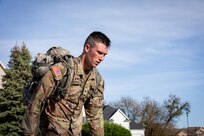 Spc. Colton Andrews, a motor transport operator with the 1463rd Transportation Company, Michigan Army National Guard, completes a 12-mile ruck march during the 2024 Region IV Best Warrior Competition in Johnston, Iowa, on May 5, 2024.