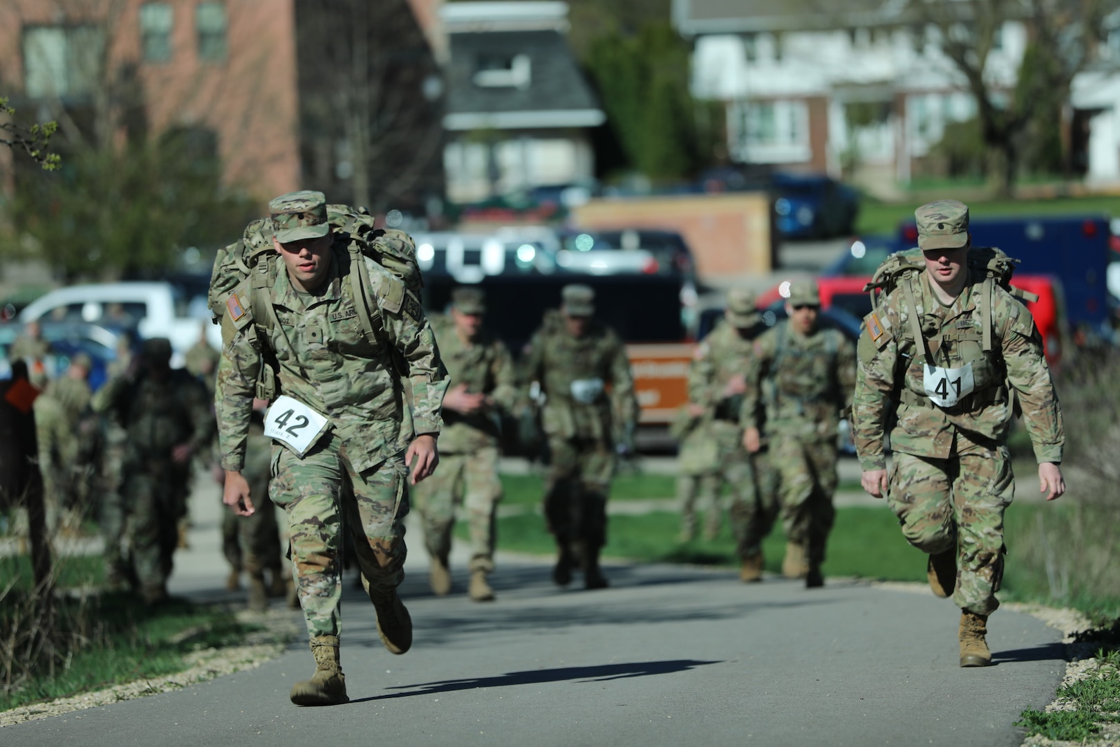 Wisconsin National Guard service members participating in the Norwegian foot march take off from the starting point at the Glacial Drumlin State Trail on April 19, 2024. The Norwegian foot march challenges participants to complete 30 kilometers (18.6 miles) while carrying at least 24 pounds in a rucksack on their back. (U.S. National Guard photo by Staff Sgt. Amber Peck)