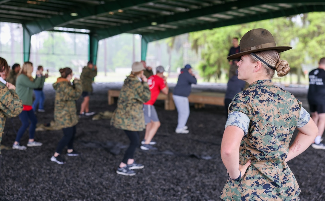 U.S. Marine Corps Staff Sgt. Kayla Reyes, a Long Island, New York native and drill instructor, observes educators practicing Marine Corps Martial Arts Program techniques during Educators Workshop at Marine Corps Recruit Depot, Parris Island, South Carolina, April 10, 2024. The purpose of the workshop is to inform high school educators and community influencers about the process of becoming a United States Marine, and to raise awareness of the opportunities and benefits for qualified individuals in the Marine Corps. (U.S. Marine Corps photo by Sgt. Bernadette Pacheco)