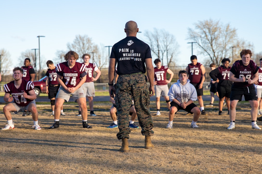 U.S. Marine Corps Capt. Terrence Zaleski, marketing and communications officer with 4th Marine Corps District, instructs physical training during the Battle of the Branches event at Madisonville North Hopkins High School, Madisonville, Kentucky on March 26, 2024. The Battle of the Branches event consisted of the U.S. Army, Air Force, Navy, and Marines competing to see who could facilitate the most difficult workout. (U.S. Marine Corps photo by Cpl. Caden Phillips)