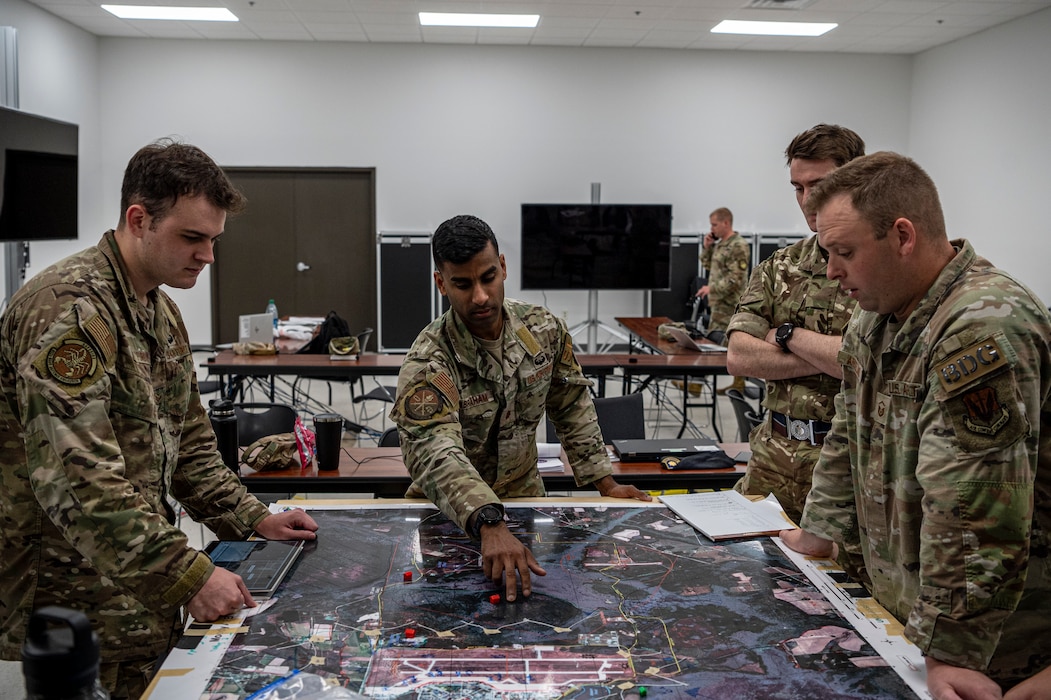 Airmen use a map