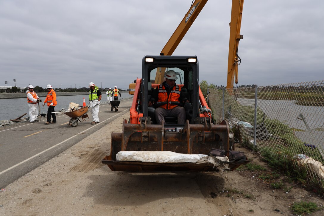 U.S. Army Corps of Engineers Los Angeles District Operations Branch equipment operator Raymond Luna removes debris from several unauthorized encampments in the inner banks of the lower Santa Ana River Marsh April 19 in Newport Beach, California.