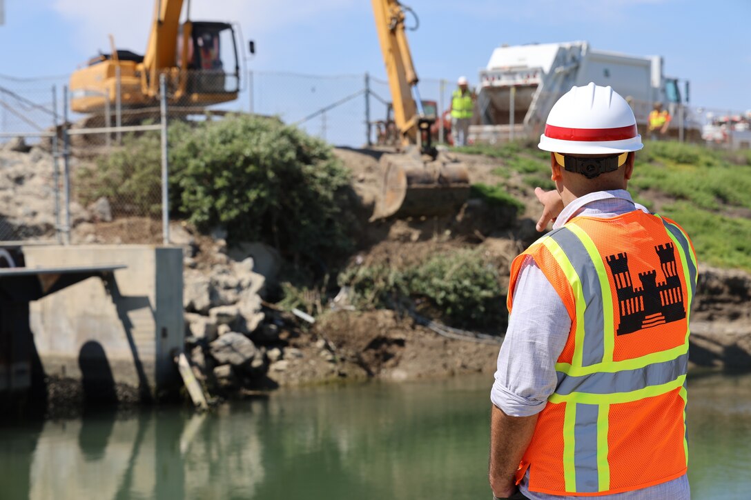 Workers with the City of Newport Beach and the Los Angeles District remove debris from several unauthorized encampments in the inner banks of the lower Santa Ana River Marsh April 19 in Newport Beach, California.