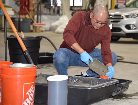 Glenn Sacro, construction control representative, fills a cylinder mold with concrete in the practical portion of the ACI Level One Concrete Certification Exam.