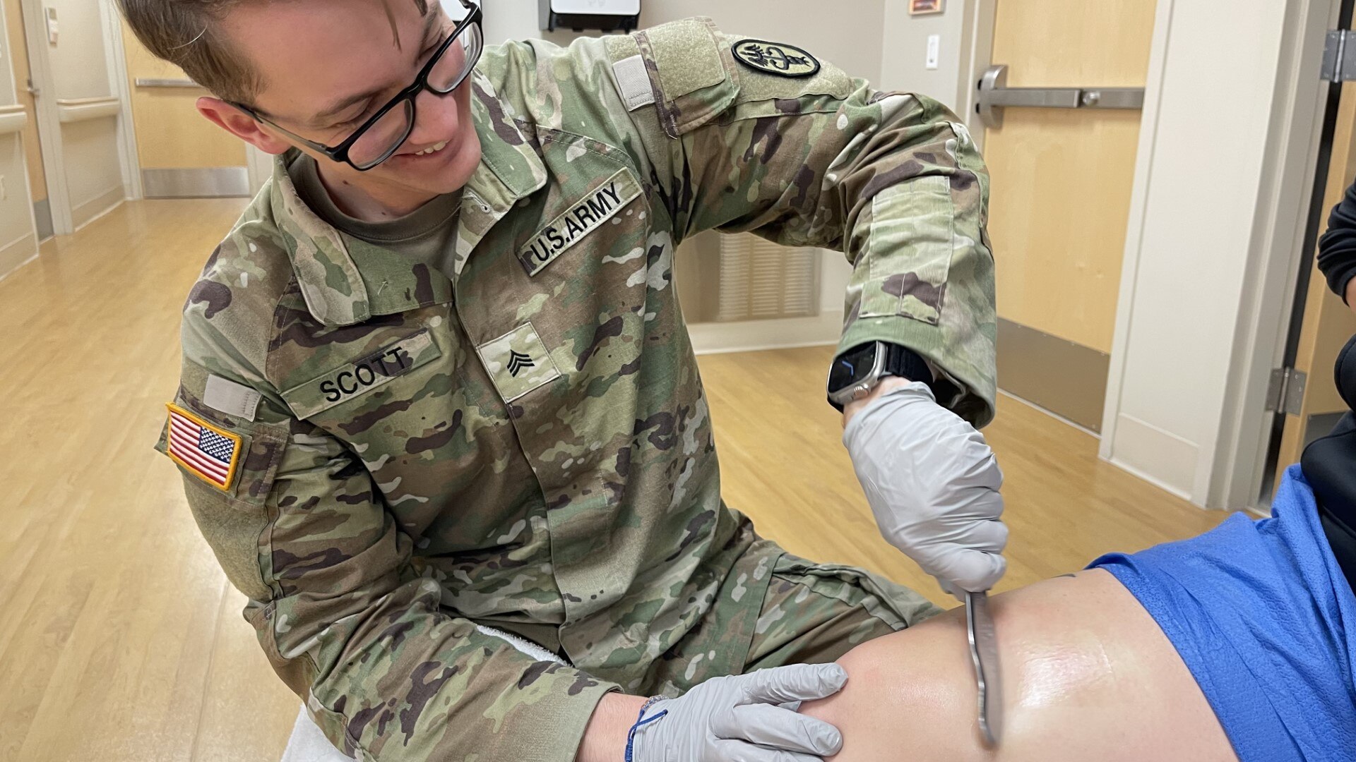 SGT Scott demonstrates soft tissue mobilization technique.