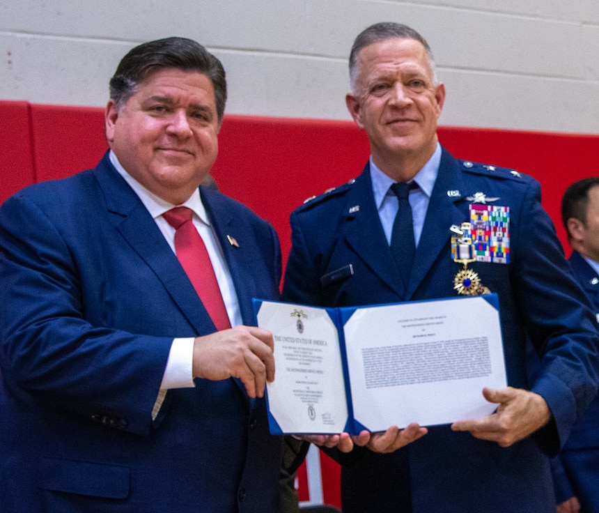 Governor JB Pritzker presents Maj. Gen. Rich Neely, the 40th Adjutant General of Illinois, with the Distinguished Service Medal during a retirement ceremony immediately following the change of command May 4 at Glenwood High School in Chatham, Illinois. Neely relinquished command of the Illinois National Guard to Maj. Gen. Rodney Boyd and retired after 40 years of military service.