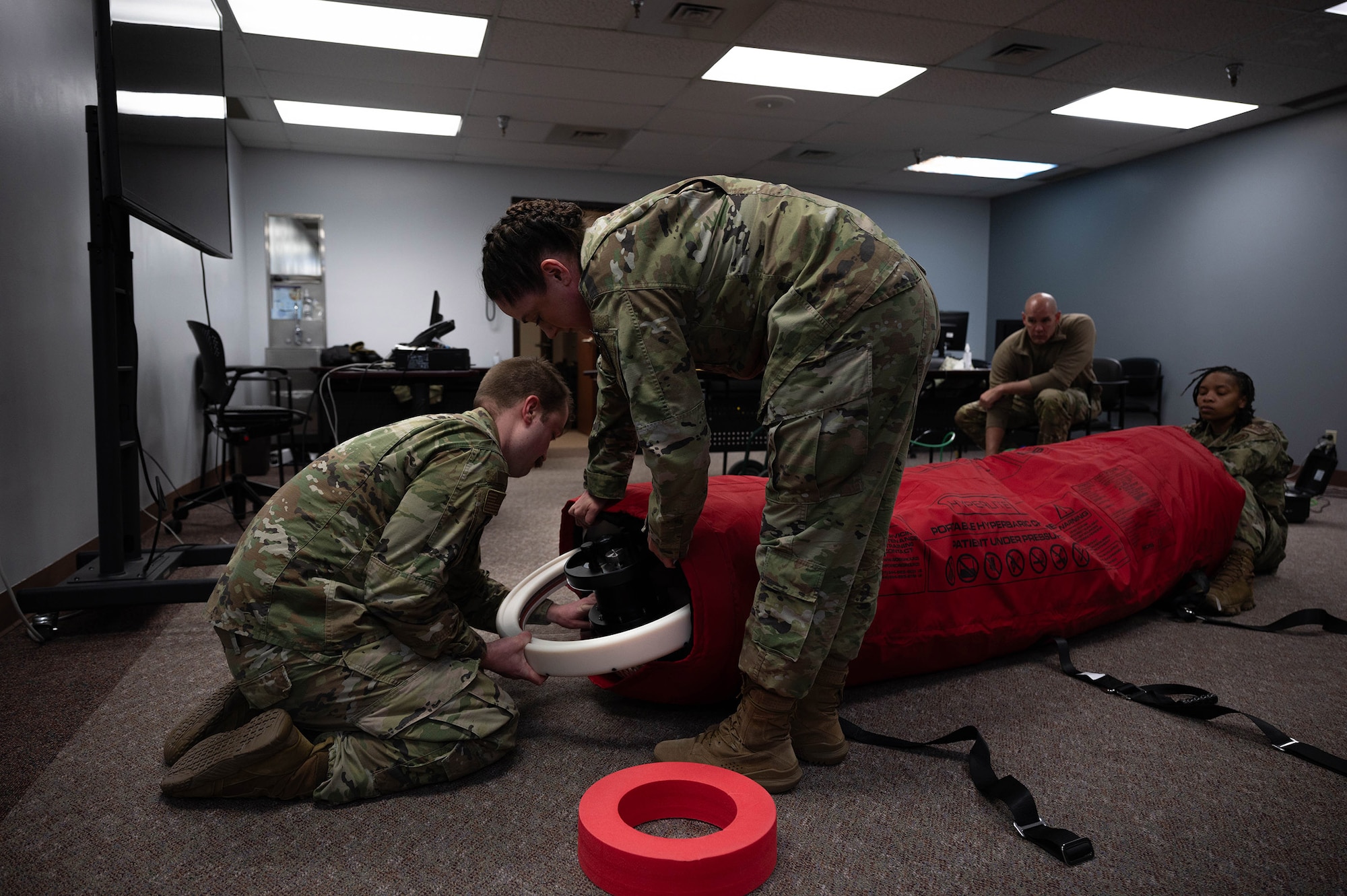 Airmen from the 354th Medical Group set up a portable decompression sickness chamber, Hyperlite 1, during a three-day hyperlite chamber training course at Eielson Air Force Base, Alaska, May 3, 2024.