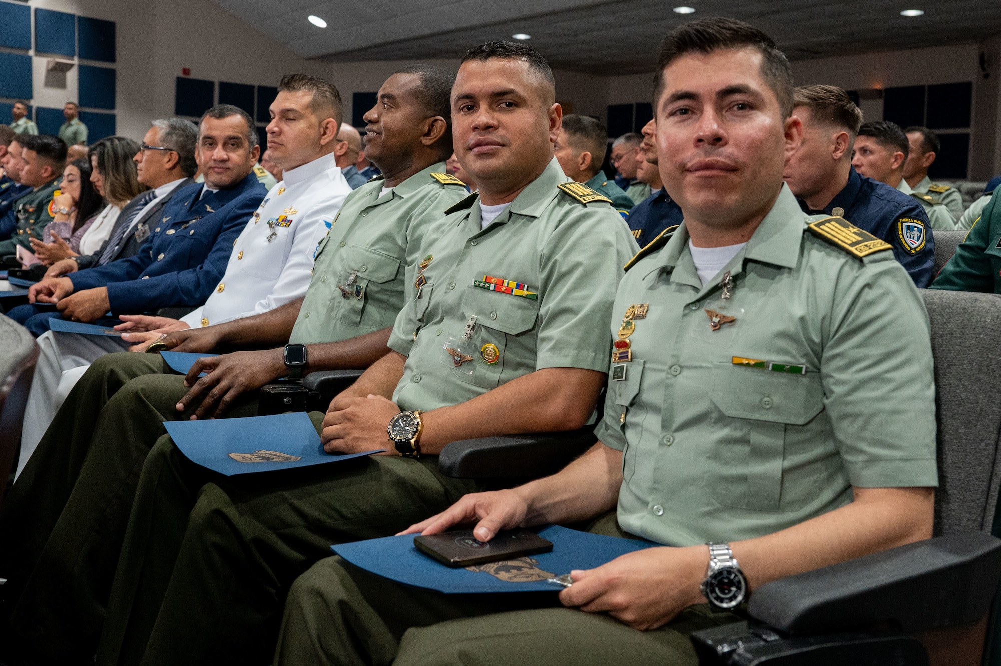 International military students sit at the Inter-American Air Forces Academy graduation ceremony at JBSA-Lackland, Texas, April 24, 2024. Approximately 90 international military students from six partner nations and the U.S. Air Force graduated during the first training cycle of 2024. IAAFA provides instruction in professional military education and leadership, aircrew training and technical courses in Spanish. (U.S. Air Force photo by Vanessa R. Adame)