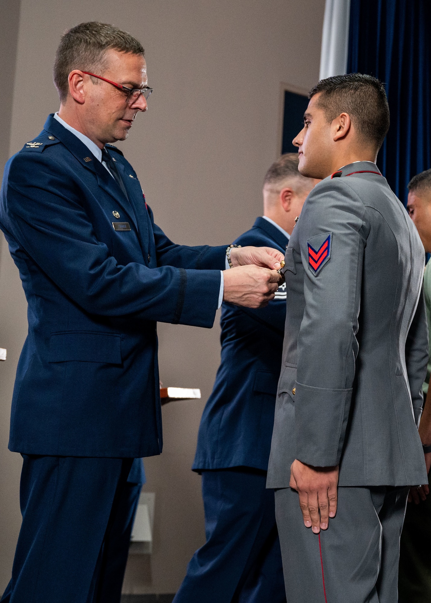 Col. Bryan Tuinman, commandant of the Inter-American Air Forces Academy, pins wings on an international military student during IAAFA’s graduation at Joint Base San Antonio-Lackland Texas, April 24, 2024. Approximately 90 international military students from six partner nations and the U.S. Air Force graduated during the first training cycle of 2024. IAAFA provides instruction in professional military education and leadership, aircrew training and technical courses in Spanish. (U.S. Air Force photo by Vanessa R. Adame)
