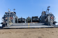 U.S. Army Soldiers with 3rd Platoon, Alpha Battery, 1st Long Range Fires Battalion, 1st Multi-Domain Task Force, and Sailors with Assault Craft Unit 5, unload an M142 High Mobility Rocket System onto Landing Craft, Air Cushion 8, during Exercise Balikatan 24 at Rizal, Luzon, Philippines, May 2, 2024. BK 24 is an annual exercise between the Armed Forces of the Philippines and the U.S. military designed to strengthen bilateral interoperability, capabilities, trust, and cooperation built over decades of shared experiences. (U.S. Marine Corps photo by Cpl. Kyle Chan)
