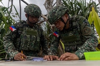 Philippine Marines plot points on a grid prior to a High Mobility Rocket System live-fire training event during Exercise Balikatan 24 at Rizal, Luzon, Philippines, May 2, 2024. BK 24 is an annual exercise between the Armed Forces of the Philippines and the U.S. military designed to strengthen bilateral interoperability, capabilities, trust, and cooperation built over decades of shared experiences. (U.S. Marine Corps photo by Cpl. Kyle Chan)