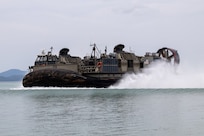 U.S. Navy Landing Craft, Air Cushion 45, attached to AssaultCraft Unit 5, prepares to land ashore with an M142 High Mobility Rocket System assigned to 3rd Platoon, Alpha Battery, 1st Long Range Fires Battalion, 1st Multi-Domain Task Force as part of a HIMARS Rapid Infiltration drill during Exercise Balikatan 24 at San Vicente, Philippines, May 1, 2024. BK 24 is an annual exercise between the Armed Forces of the Philippines and the U.S. military designed to strengthen bilateral interoperability, capabilities, trust, and cooperation built over decades of shared experiences. (U.S. Marine Corps photo by Cpl. Kyle Chan)