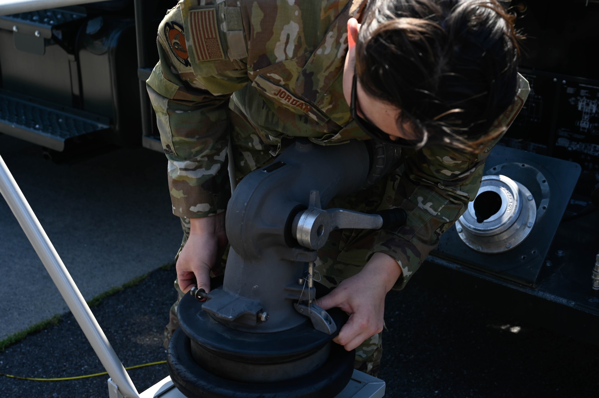 An Airman takes off a fuel pump from the moosehead prototype.