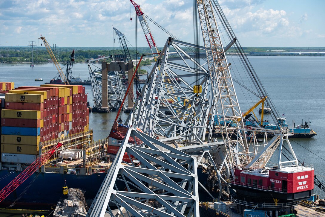 Salvors cut pieces of debris from a support structure of the Francis Scott Key Bridge in Baltimore.