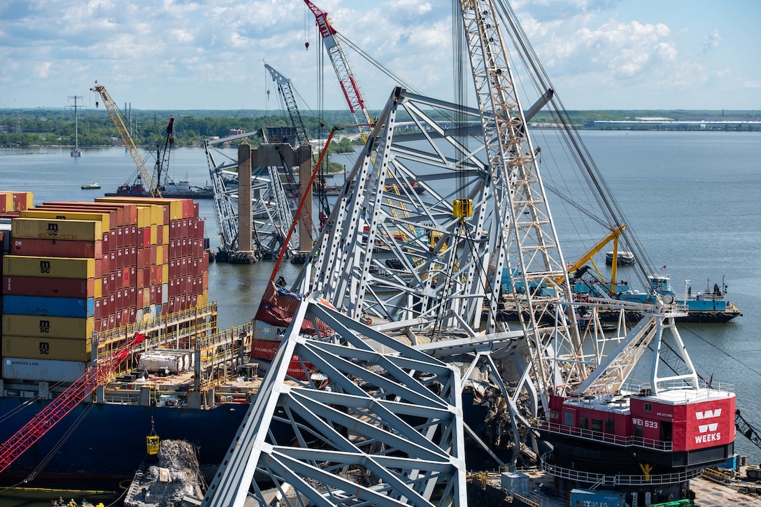 Salvors cut pieces of debris from a support structure of the Francis Scott Key Bridge in Baltimore.