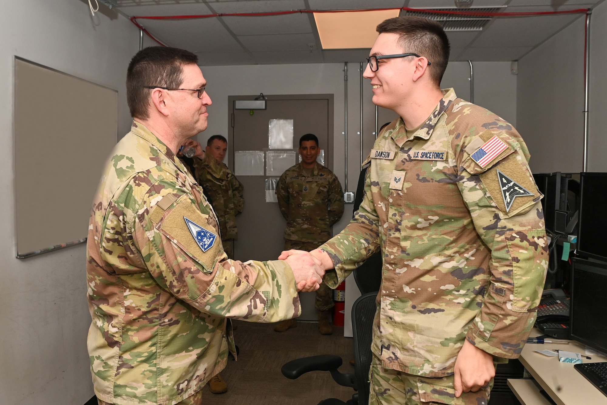 U.S. Space Force Chief of Space Operations Gen. Chance Saltzman, left, presents his coin to U.S. Space Force Specialist 4 Bradley Dawson, 5th Space Warning Squadron, Detachment 3, during a visit to Osan Air Base, Republic of Korea, May 6, 2024.