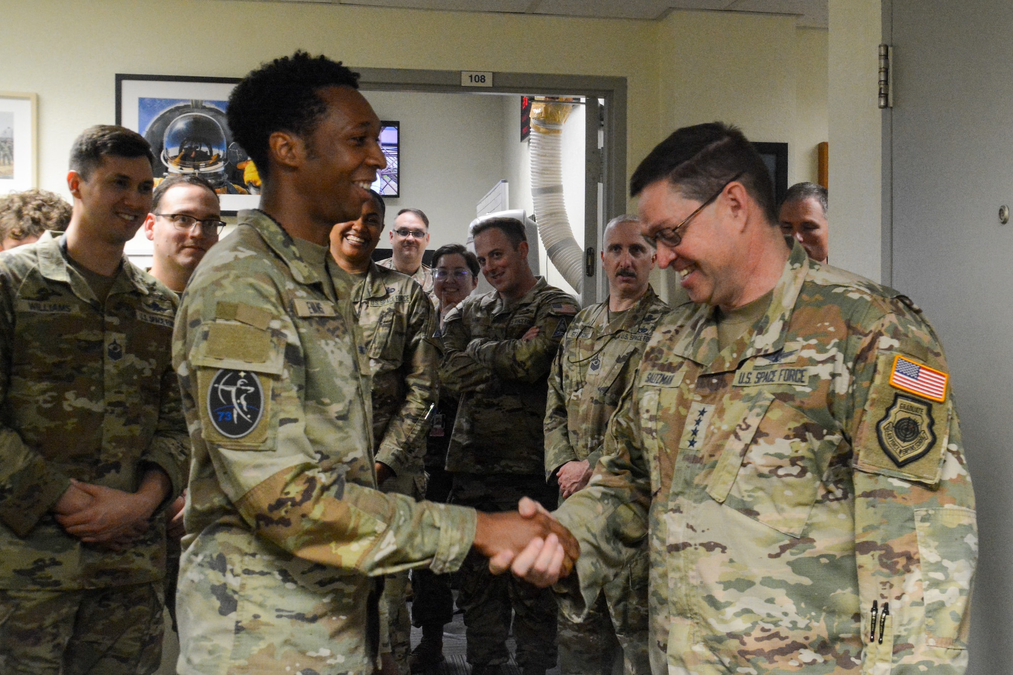 U.S. Space Force Chief of Space Operations Gen. Chance Saltzman, right, receives a 73rd Intelligence, Surveillance and Reconnaissance Squadron, Detachment 2 coin from U.S. Space Force Specialist 4 Charles Evans, during a visit to Osan Air Base, Republic of Korea, May 6, 2024.