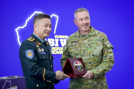 Brig. Gen. B. Uuganbayar, left, deputy director of the Mongolian National Emergency Management Agency, presents a commemorative anniversary plaque to Australian Maj. Gen. Scott Winter, deputy commanding general - strategy and plans for the U.S. Army Pacific, during the Gobi Wolf 2024 opening ceremony at the Governor’s Palace in Choibalsan, Mongolia, May 7, 2024. Gobi Wolf is an annual joint exercise coordinated by the Mongolian National Emergency Management Agency and U.S. Army Pacific that focuses on interagency coordination within Mongolia, as well as foreign humanitarian assistance during a large-scale natural disaster.