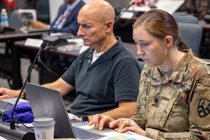 Lt. Col. Jennifer Pampuch Borden, right, and Col. John Trevino, 469th Finance Support Center deputy director and director, respectively, take notes during the last day of the U.S. Army Financial Management Command's Theater Finance Support Update at the Maj. Gen. Emmett J. Bean Federal Center in Indianapolis May 1, 2024. The TFSU focused on synchronization, data sharing, best practices, and coordination for finance and comptroller units rotating into the U.S. Central Command and European Command Areas of Responsibility. (U.S. Army photo by Mark R. W. Orders-Woempner)