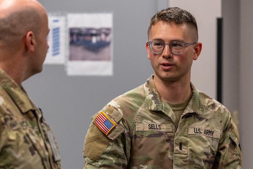 1st Lt. Caleb Sells, 45th Finance Center finance operations officer, talks with Lt. Col. Jason L. Shick, 45th FC acting director, during the U.S. Army Financial Management Command's Theater Finance Support Update at the Maj. Gen. Emmett J. Bean Federal Center in Indianapolis May 1, 2024. The TFSU focused on synchronization, data sharing, best practices, and coordination for finance and comptroller units rotating into the U.S. Central Command and European Command Areas of Responsibility. (U.S. Army photo by Mark R. W. Orders-Woempner)