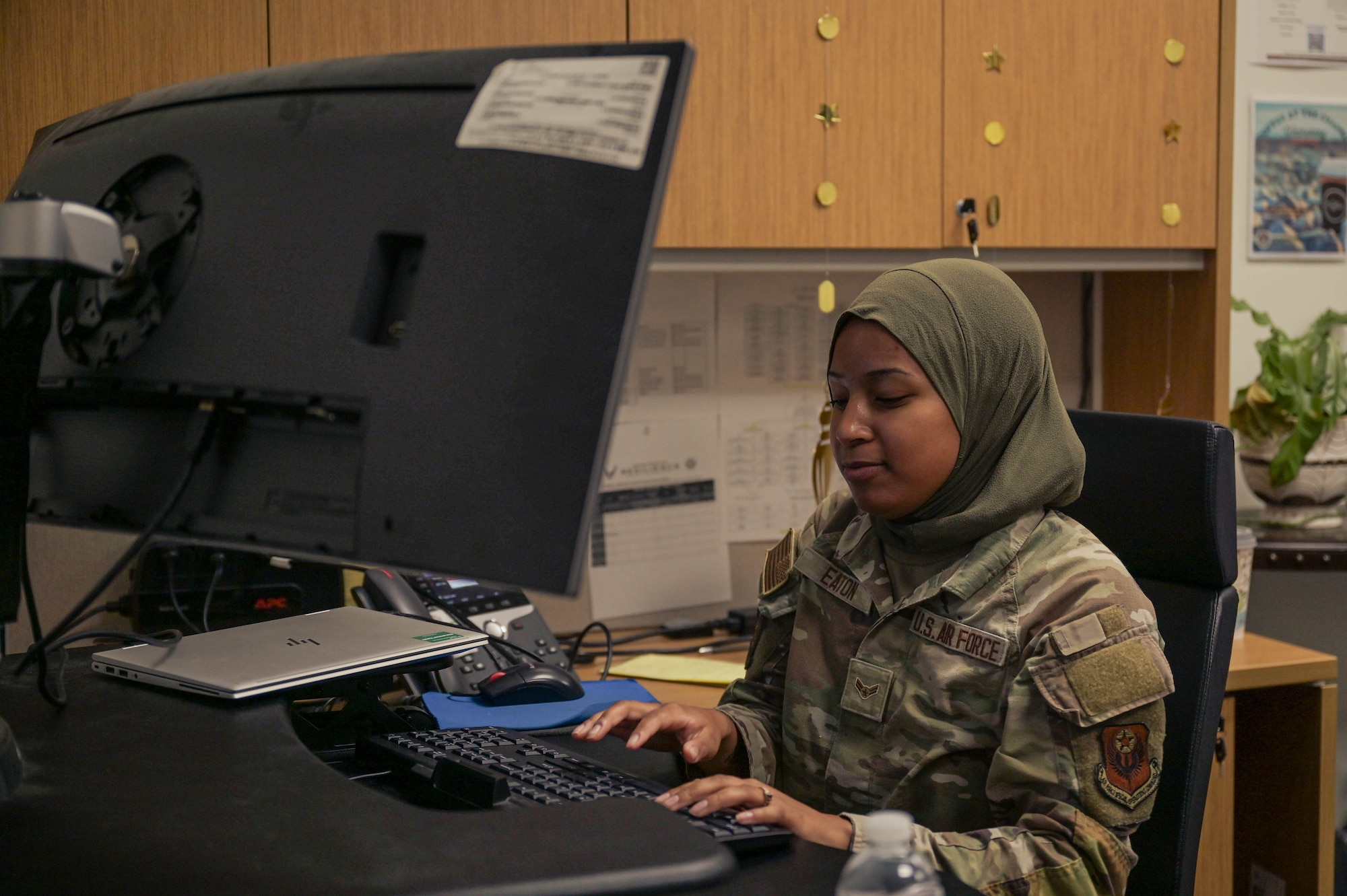 U.S. Air Force Airman 1st Class Nya Eaton, a 1st Special Operations Wing religious affairs Airman, works at a computer at the Chapel at Hurlburt Field, Florida, April 16, 2024.