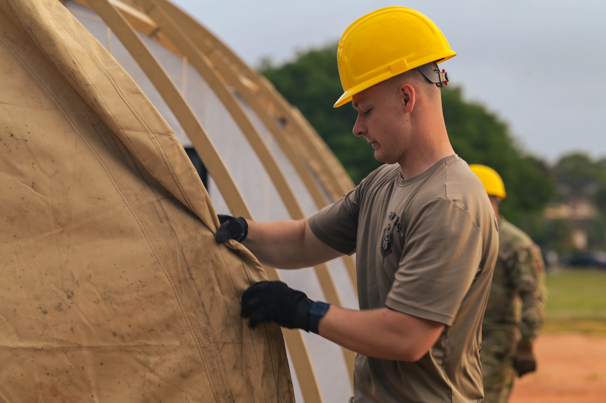 U.S. Air Force Airman 1st Class Roman Paprzycki, 1st Special Operations Civil Engineer Squadron engineering assistant, assembles a tent during an expeditionary day at Hurlburt Field, Florida, April 19, 2024.