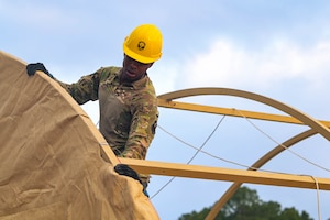 U.S. Air Force Airman Marshall McGowen, 1st Special Operations Civil Engineer Squadron electrical power production apprentice, assembles a tent during an expeditionary day at Hurlburt Field, Florida, April 19, 2024.