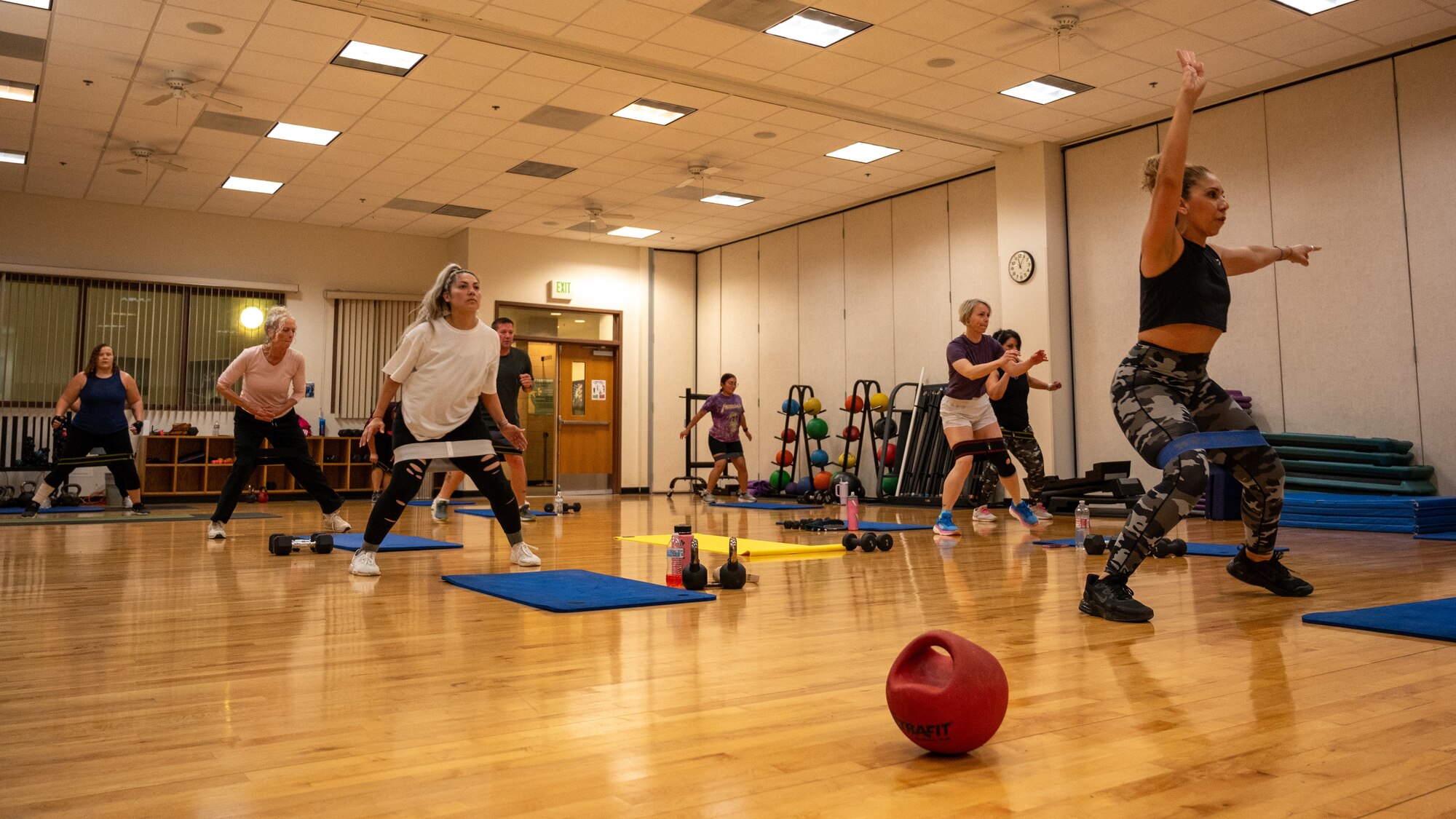 Airmen run through a fitness class led by Ms. Poloma Felan in the Losano Fitness Center at Laughlin Air Force Base, Texas, April 25, 2024. Structured fitness classes are an excellent way for Airmen to stay in shape, being led through a measured workout by an instructor. (U.S. Air Force photo by Staff Sgt. Nicholas Larsen)