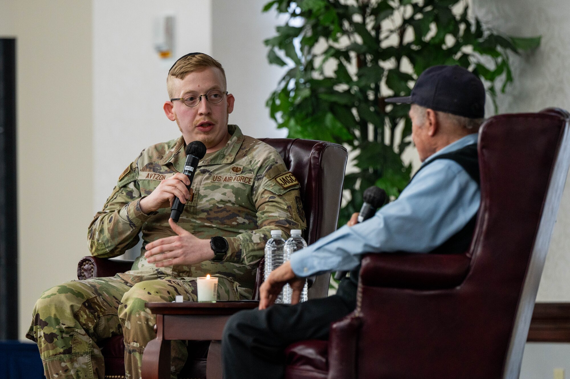 Man speaks to Holocaust Survivor.