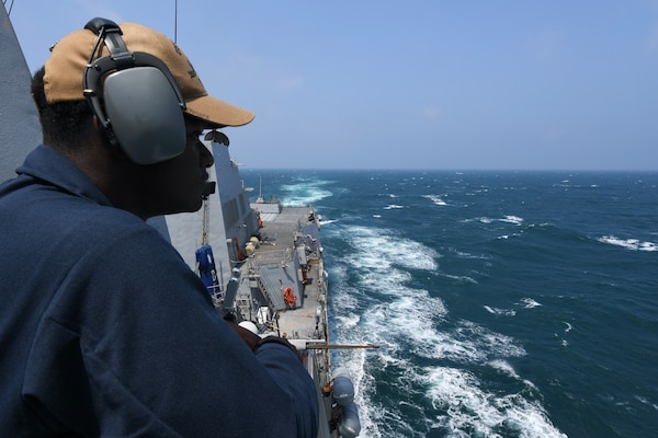 Seaman Gary Beckles, from Laurel, Maryland, stands port lookout aboard the Arleigh Burke-class guided-missile destroyer USS Halsey (DDG 97) during routine underway operations while transiting through the Taiwan Strait, May 8. Halsey is forward-deployed and assigned to Destroyer Squadron (DESRON) 15, the Navy’s largest DESRON and the U.S. 7th Fleet’s principal surface force.