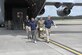 Four participants in Exercise Distant Storm 24-01 carry a patient from a C-17 Globemaster III to the base hanger staging area on May 4.  Westover hosted multiple federal and state agencies to stage a mass casualty evacuation exercise during the May unit training assembly.