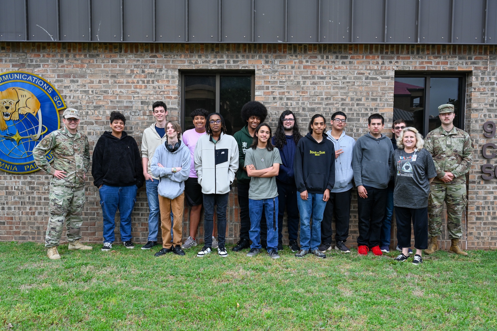 Students from Altus High School’s robotics class and Airmen from Altus Air Force Base (AFB), Oklahoma, pose for a photo in front of the 97th Communications Squadron at Altus AFB, Oklahoma, May 2, 2024. The students visited the unit and learned about the squadron’s daily responsibilities. (U.S. Air Force photo by Airman 1st Class Jonah G. Bliss)