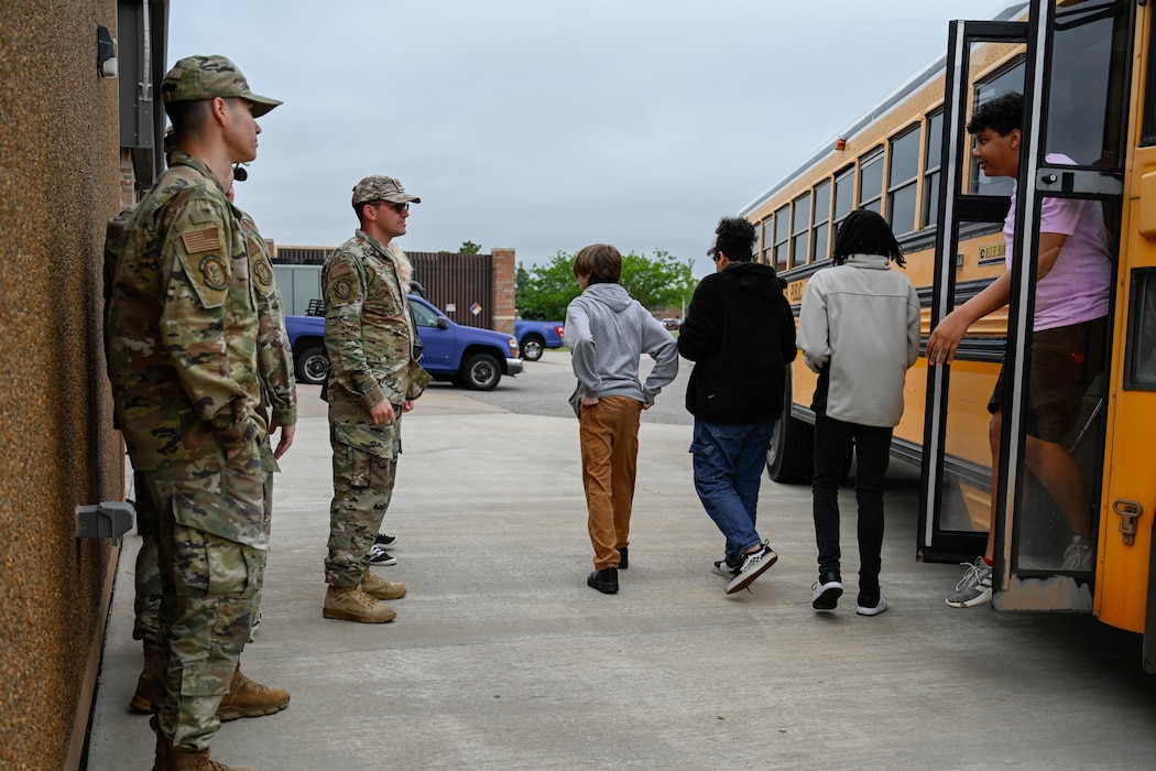 Airmen from the 97th Communications Squadron (CS) greet Altus High School students at Altus Air Force Base, Oklahoma, May 2, 2024. The 97th CS develops and implements Information Technology solutions and communications security functions in support of the 97th Air Mobility Wing. (U.S. Air Force photo by Airman 1st Class Jonah G. Bliss)