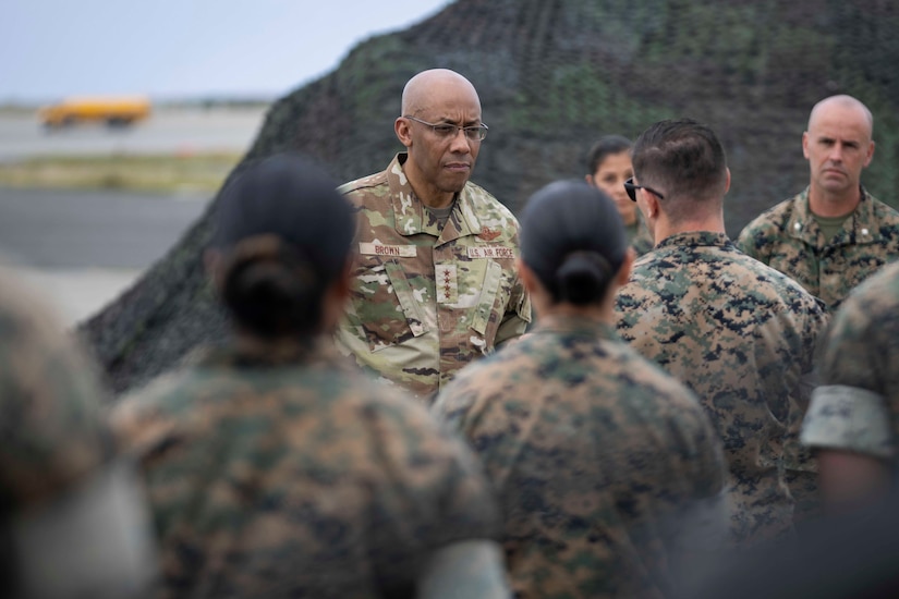 A military officer speaks to service members.