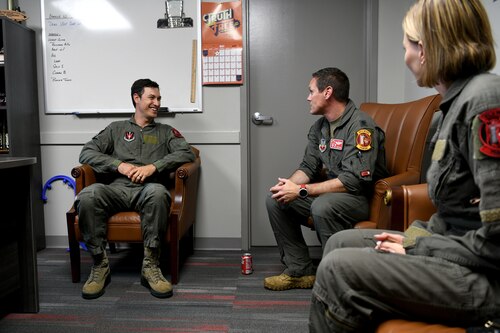 U.S. Air Force Lt. Col. Daniel Trueblood, 77th Fighter Squadron commander, center, speaks with NASCAR driver Joey Logano, left, prior to their flight in an F-16 Fighting Falcon at Shaw Air Force Base, S.C., May 7, 2024. Trueblood used the time to explain to Logano the mission set they would be performing while in the air, and the things to look out for as they fly. (U.S. Air Force photo by Staff Sgt. Kelsey Owen)