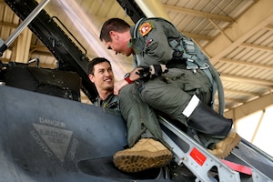 U.S. Air Force Lt. Col. Daniel Trueblood, 77th Fighter Squadron commander, right, assists NASCAR driver Joey Logano with preparing for a flight in an F-16 Fighting Falcon at Shaw Air Force Base, S.C., May 7, 2024. Shaw is home to the 20th Fighter Wing, the largest active duty combat F-16 wing in the U.S. comprising three Fighter Squadrons: the 55th “Shooters”, the 77th “Gamblers”, and the 79th “Tigers”. (U.S. Air Force photo by Staff Sgt. Kelsey Owen)