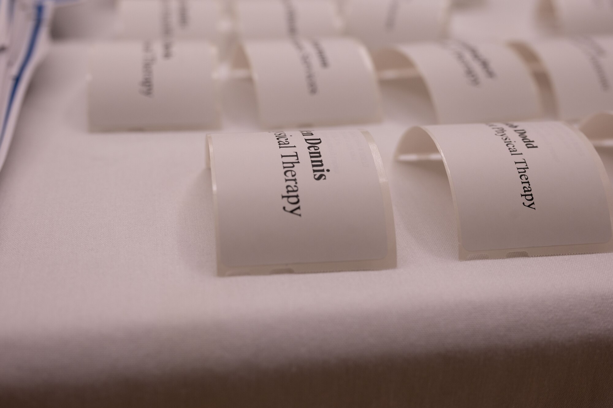 Name tags sit on a table during the 436th Medical Group Community Providers Meet and Greet on Dover Air Force Base, Delaware, May 2, 2024. This event aided in Team Dover’s commitment to building partnerships in the surrounding community. (U.S. Air Force Photo by Airman 1st Class Dieondiere Jefferies)