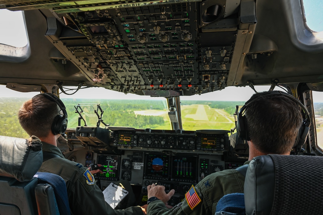 U.S. Air Force Capt. Ryan Radka, left, 58th Airlift Squadron instructor pilot, and Col. John Masterson, right, 97th Operations Group commander, prepare to land on a semi-prepared runway operation in a C-17 Globemaster III aircraft at Fort Johnson, Louisiana, April 30, 2024. The runway was 3,369 feet long and 92 feet wide. (U.S. Air Force photo by Airman 1st Class Jonah G. Bliss)