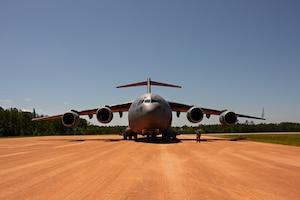 A C-17 Globemaster III aircraft assigned to the 97th Air Mobility Wing on a semi-prepared runway at Fort Johnson, Louisiana, April 30, 2024. The C-17 can take off and land on runways as short as 3,500 feet long and 90 feet wide. (U.S. Air Force Photo by Airman 1st Class Jonah G. Bliss)