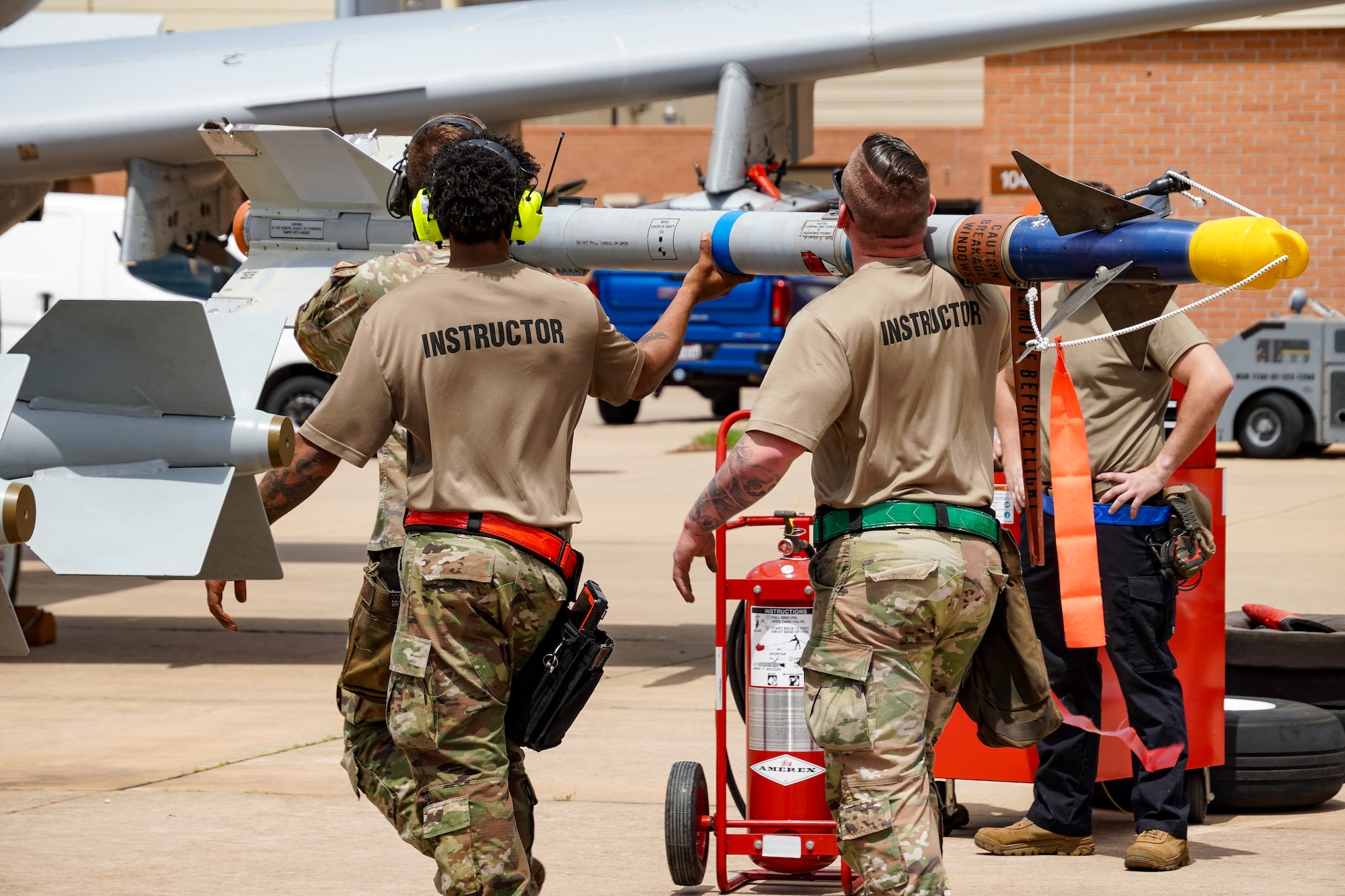 Airmen carry a bomb