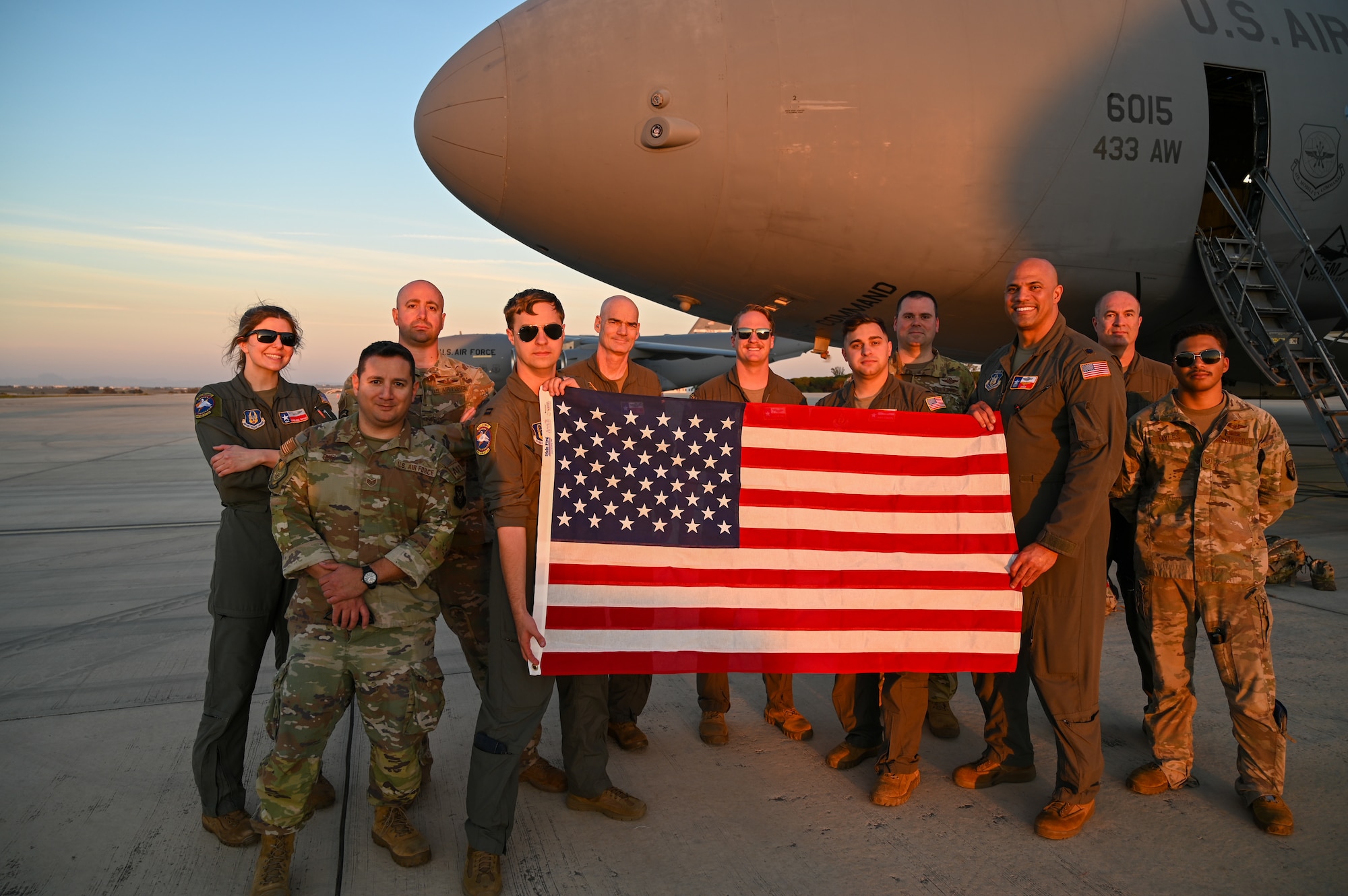 The 68th Airlift Squadron aircrew take a group photo with Col. William Gutermuth, 433rd Airlift Wing commander, and Lt. Col. Christopher Jones, 356th Airlift Squadron commander, in front of the C-5M Super Galaxy on the flightline at Naval Station Rota, Spain Apr. 11, 2024.