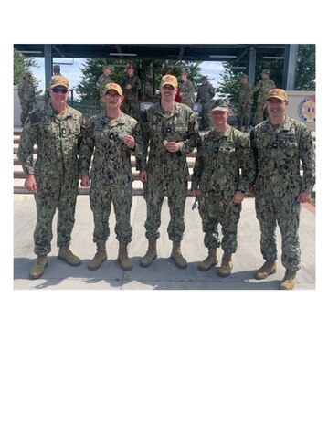 From left to right are Command Master Chief Hospital Corpsman Brandon Lindbeck, Hospital Corpsman 3rd Class Thomas Bryans, Hospital Corpsman 3rd Class Maxwell Church, Capt. Matthew Marcinkiewicz, NMRLC's commanding officer and Capt. Brian Hatch, Director, Naval Ophthalmic Readiness Activity (NORA).  here, Church and Bryans hold their proficiency badge after having successfully completed the requirements to earn the German Armed Forces Proficiency Badge.