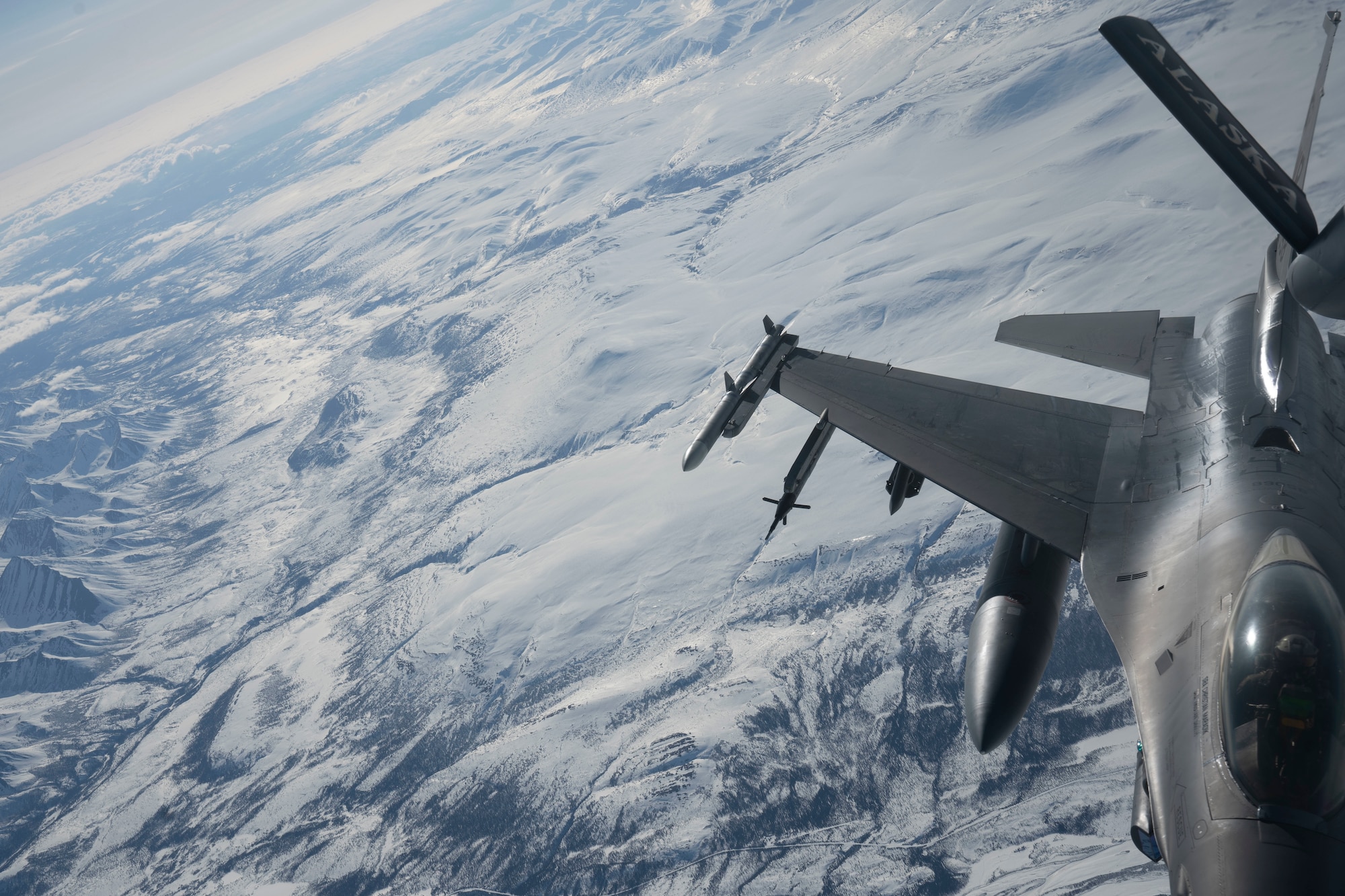 A U.S. Air Force F-16 Fighting Falcon assigned to the 354th Fighter Wing, Eielson Air Force Base, Alaska, receives fuel from a KC-135 Stratotanker assigned to the 909th Air Refueling Squadron, Kadena Air Base, Japan, over the Joint Pacific-Alaska Range Complex, during RED FLAG-Alaska 24-1, Apr. 26, 2024. The KC-135 was recently transferred to the 909th ARS from the Alaska Air National Guard. RED FLAG-Alaska provides unique opportunities to integrate various forces into joint, coalition and multilateral training from simulated forward operating bases. (U.S. Air Force Photo by Senior Airman Julia Lebens)