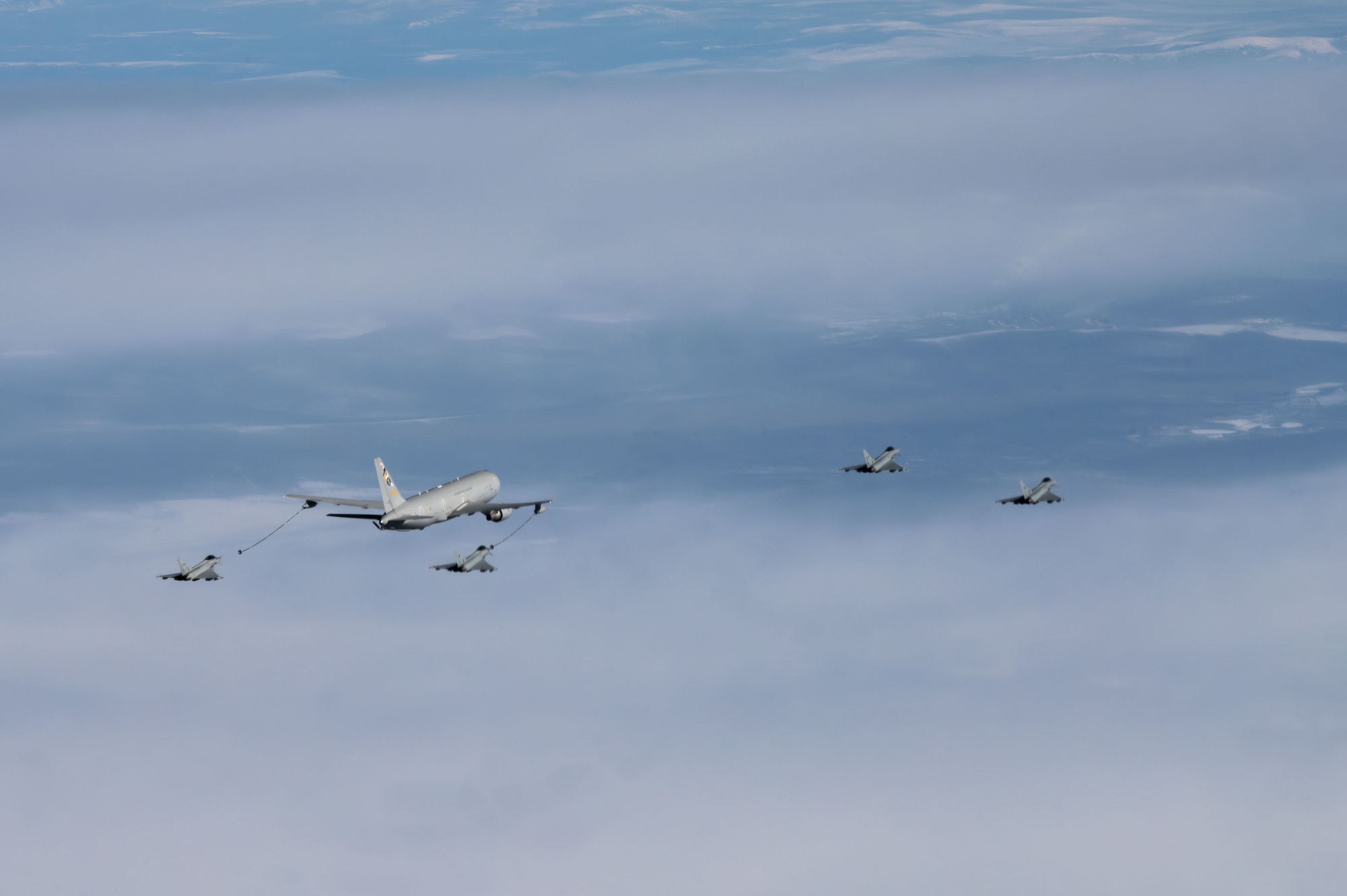 An Italian Air Force KC-767A tanker refuels two F-2000 Eurofighter Typhoons, Aeronautica Militare, over the Joint Pacific-Alaska Range Complex during RED FLAG-Alaska 24-1, May 2, 2024. RED FLAG-Alaska hosted the first U.S. Air Force KC-46 and Italian Air Force KC-767A formation flight. (U.S. Air Force Photo by Airman Raina Dale)