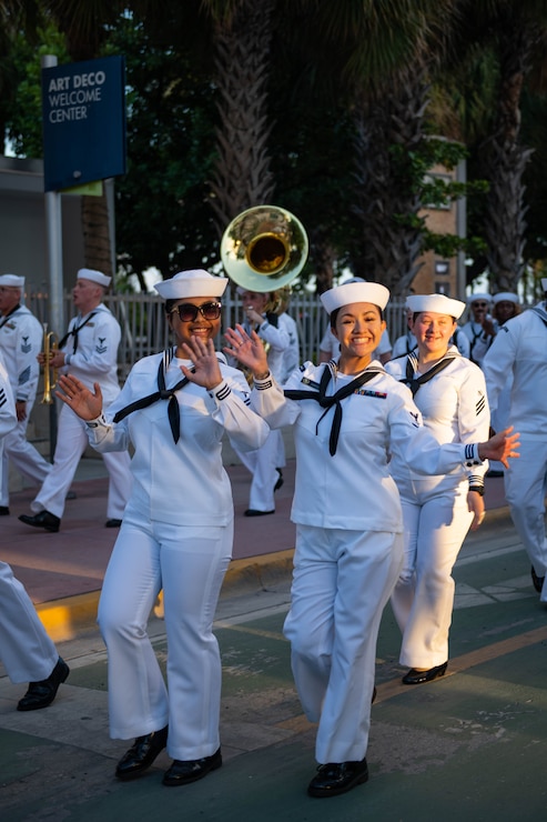 MIAMI - (May 6, 2024) U.S. Navy Hospitalman Apprentice Kaila Kien, from Bridgeport, Conn., left, and Hospital Corpsman 3rd Class Brianah Jimenez, from El Paso, Texas, assigned to Navy Medicine Readiness and Training Command (NMRTC) Jacksonville, wave to the crowd during a parade during Fleet Week Miami, May 6, 2024.