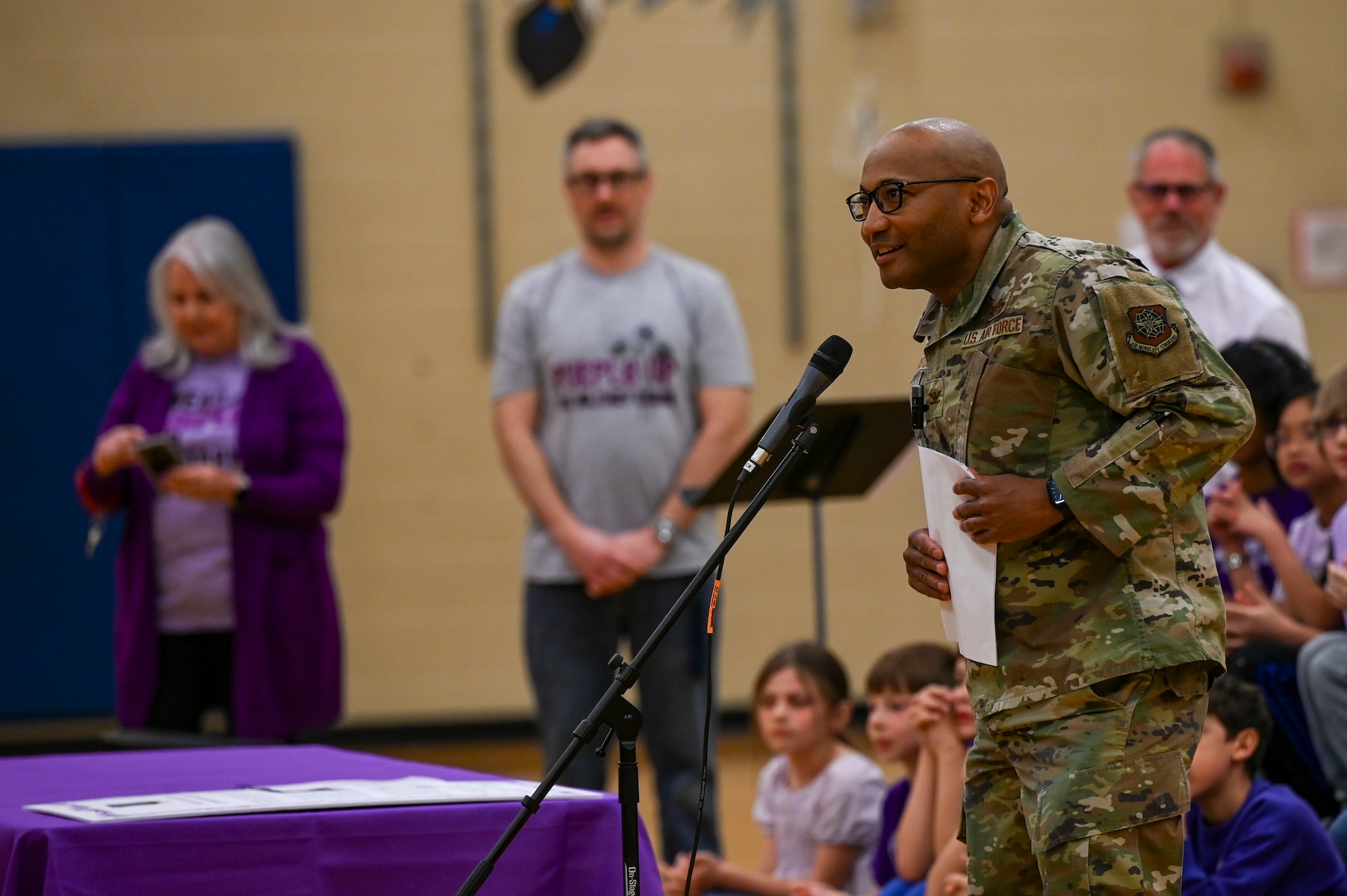 A Colonel speaks to children at a school.