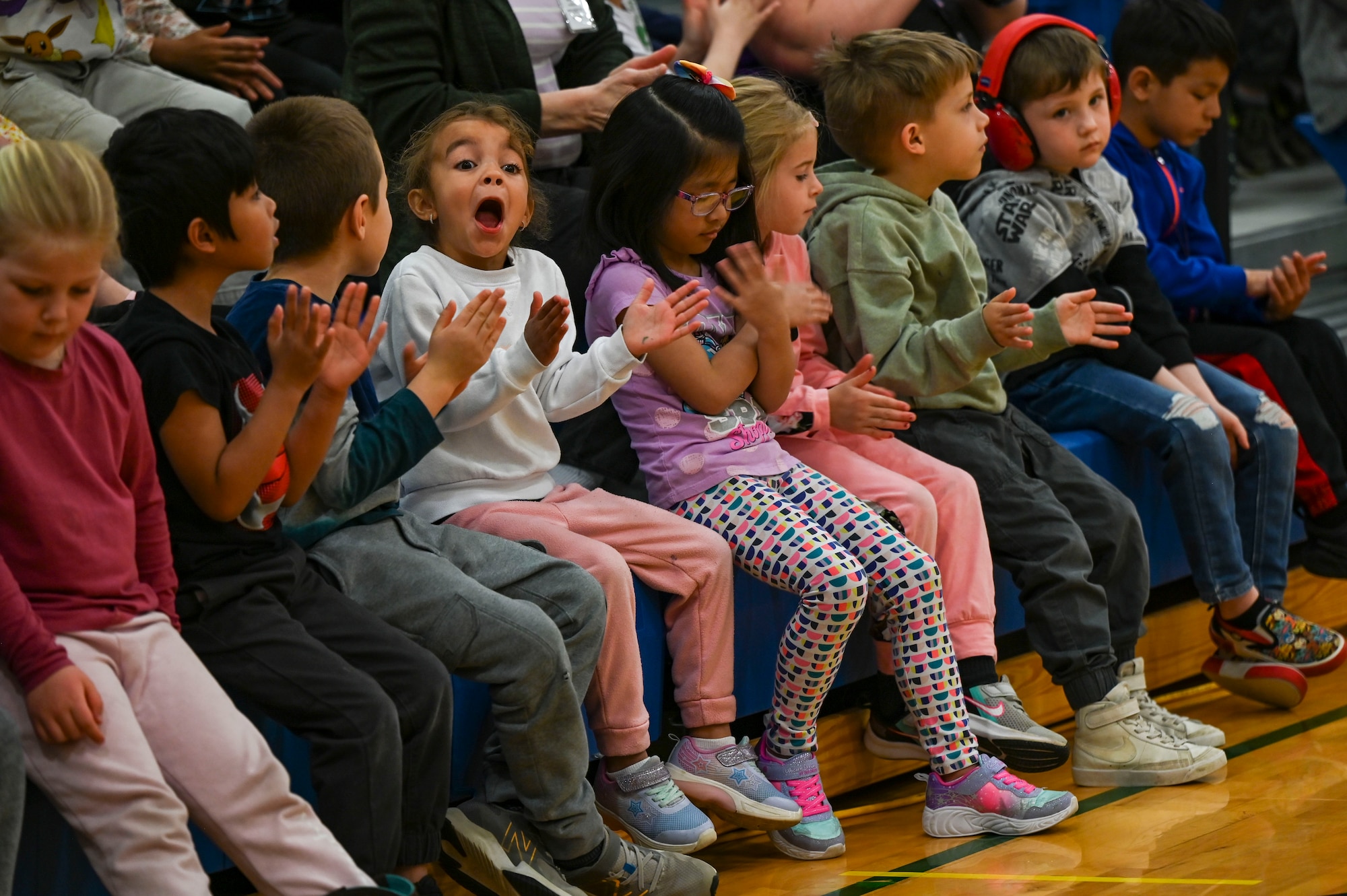 Children applaud in an audience.
