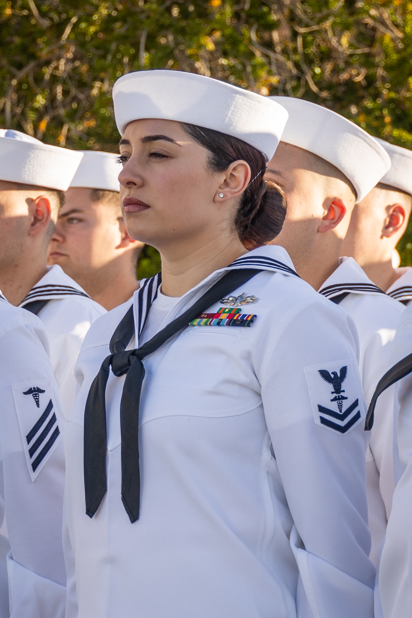 U.S. Navy Sailors stand at attention during a command dress whites inspection at the Robert E. Bush Naval Hospital, Marine Corps Air-Ground Combat Center, Twentynine Palms, California, April 19, 2024. The inspection is conducted annually in preparation for the Navy’s seasonal uniform change. (U.S. Marine Corps photo by Lance Cpl. Enge You)